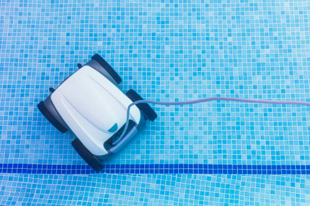 Underwater pool vacuum cleaner. Robotic cleaning of the pool floor. Pool cleaner robot Pool maintenance with automatic robot. Cleaning the bottom of the pool and walls with a submersible robot.